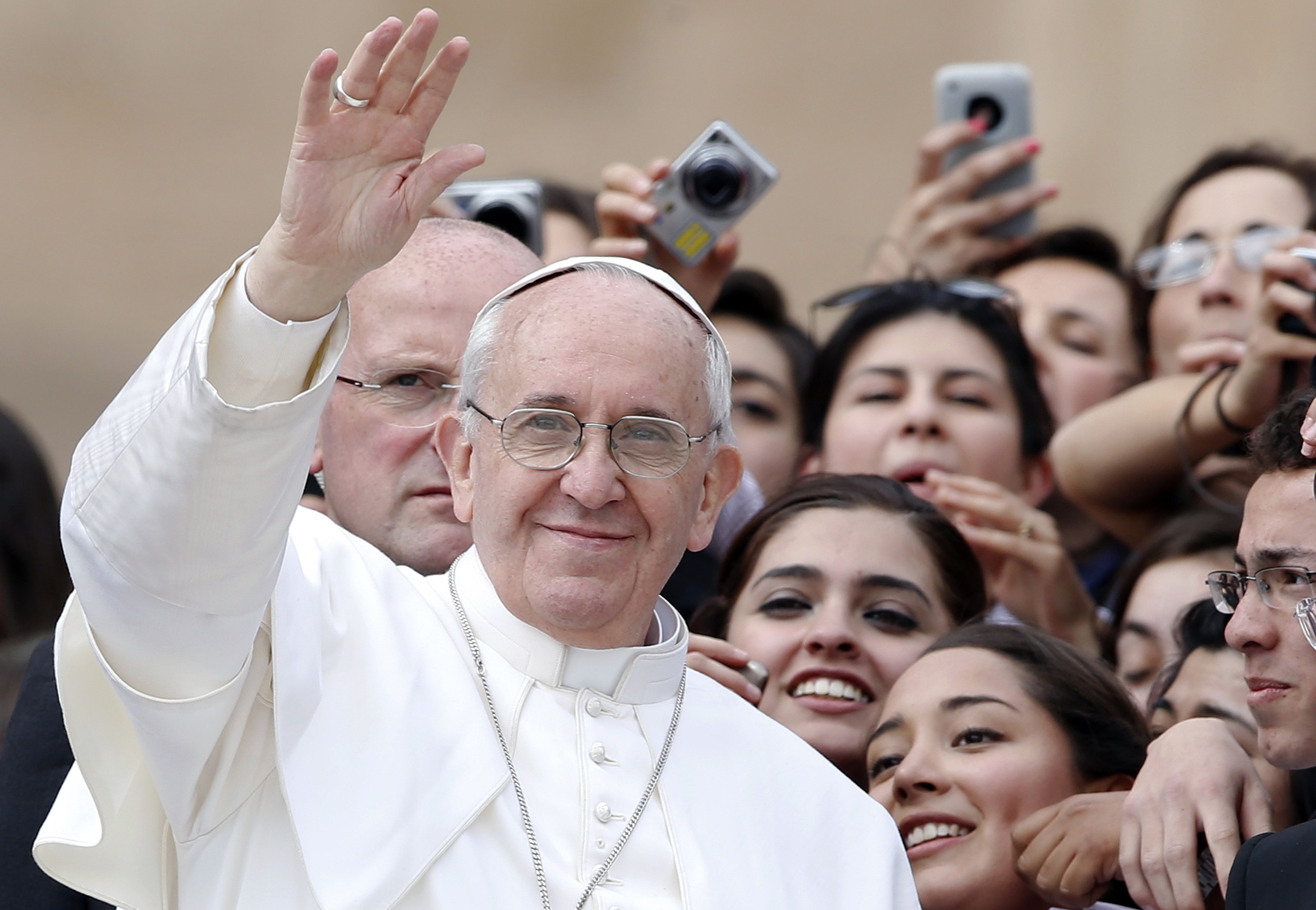 Pope Francis waves as he leaves at the end of the weekly general audience in Saint Peter's Square at the Vatican