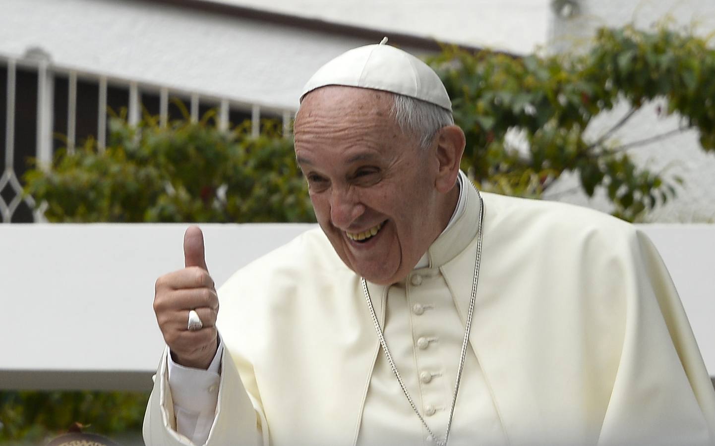 Pope Francis gives his thumb up from the popemobile in Quito, on July 7, 2015. Pope Francis celebrated his second open air mass in Ecuador and has called for greater "dialogue" and "participation without exclusion". AFP PHOTO / JUAN CEVALLOS