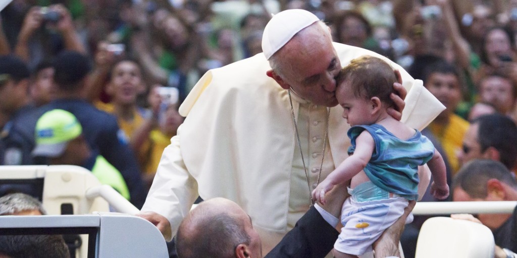 RIO DE JANEIRO, BRAZIL - JULY 22: Pope Francis kisses a baby while departing the Metropolitan Cathedral in the Popemobile after arriving in Rio on July 22, 2013 in Rio de Janeiro, Brazil. More than 1.5 million pilgrims are expected to join Pope Francis for his visit to the Catholic Church's World Youth Day celebrations. (Photo by Alexandro Auler/LatinContent/Getty Images)